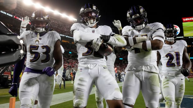 Del'Shawn Phillips (53), safety Marcus Williams (32), and cornerback Daryl Worley stand in the end zone with their arms crossed in celebration